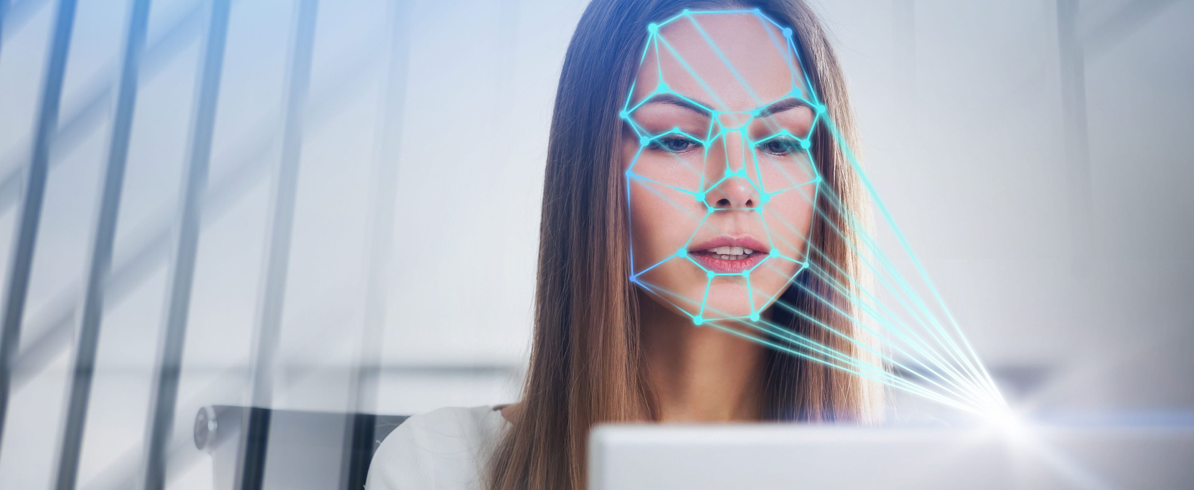 Woman looking at a computer emotion recognition