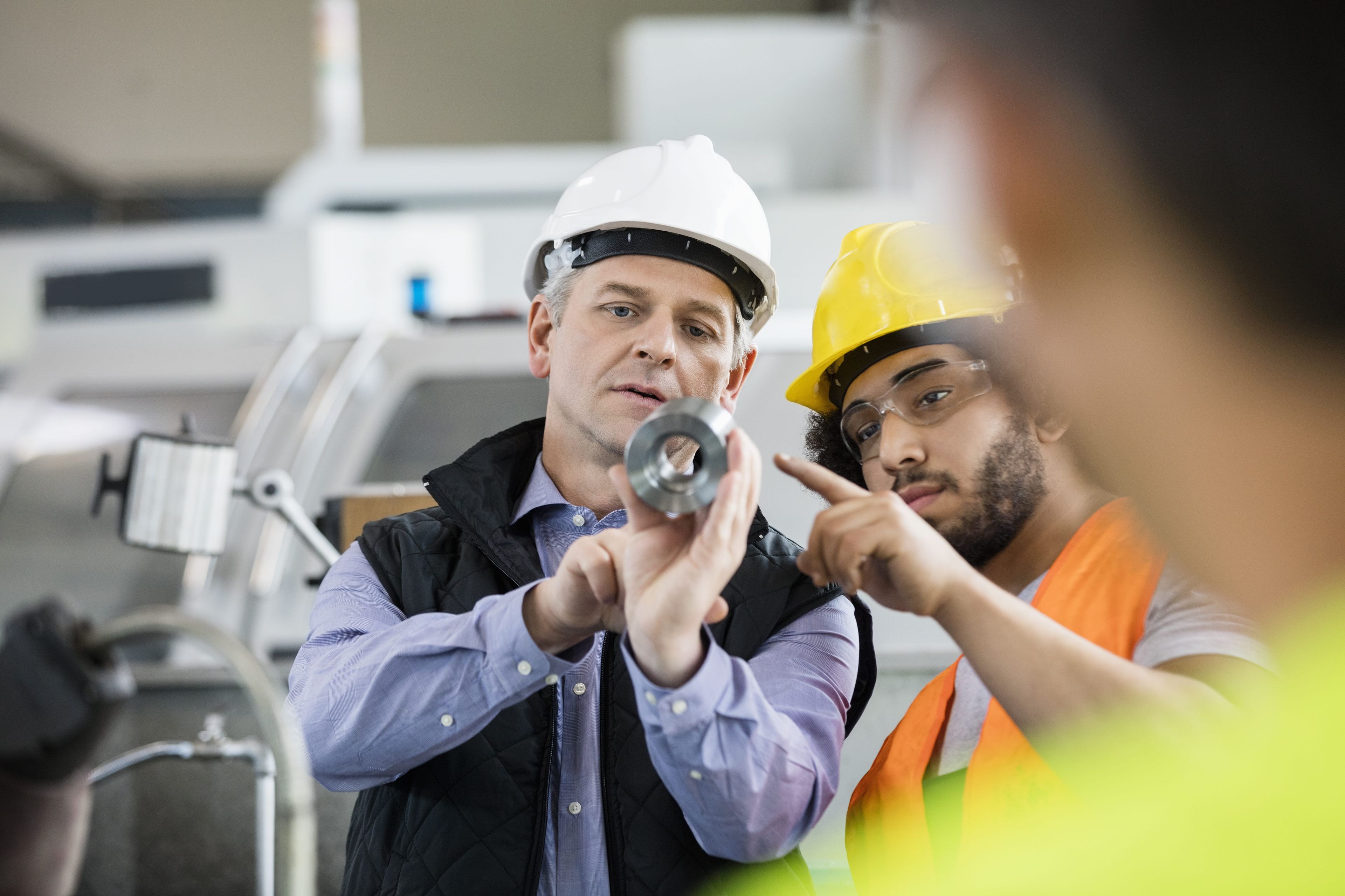 Men are inspecting parts.
