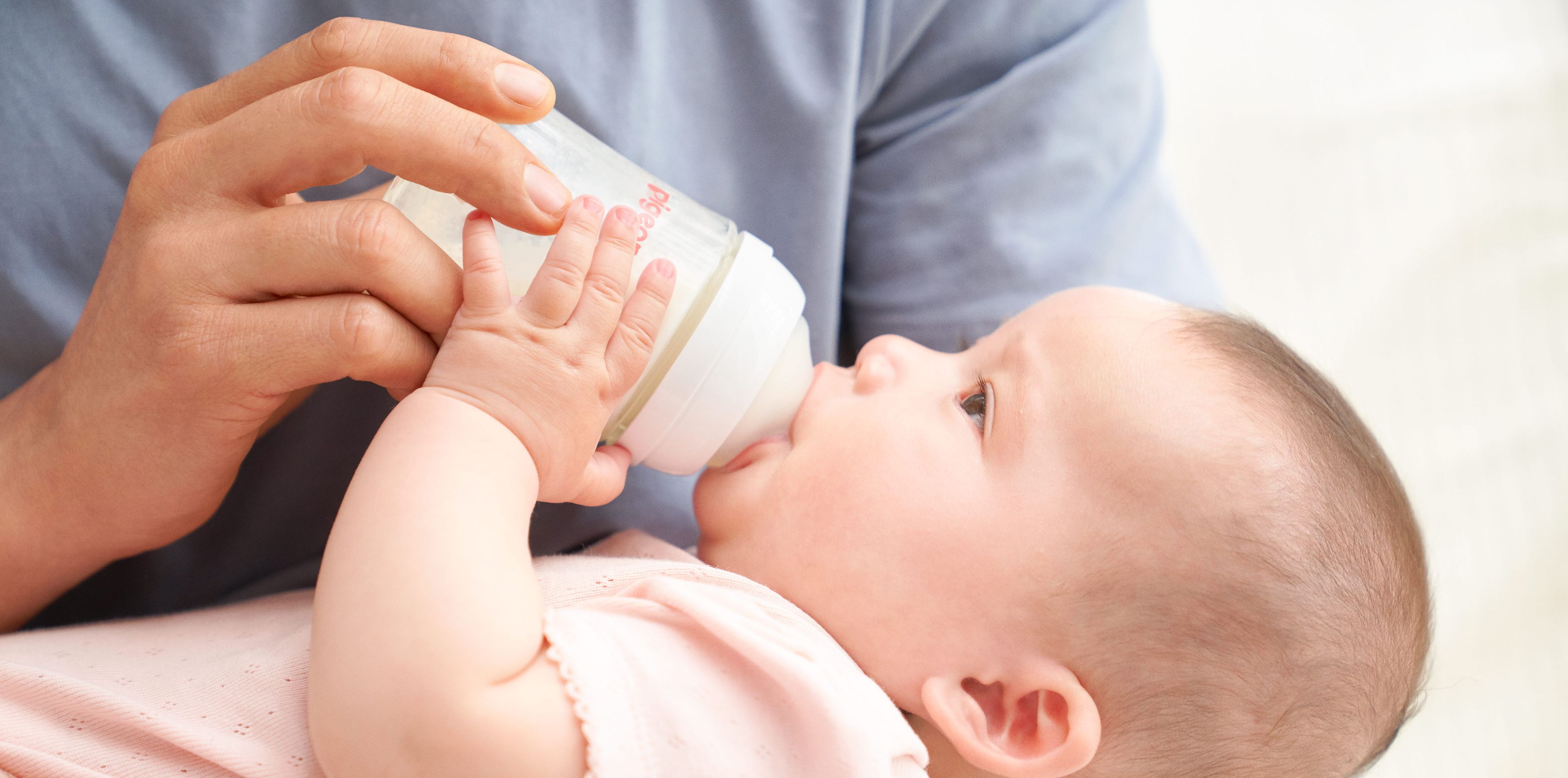 Baby drinking out of a Pigeon baby bottle