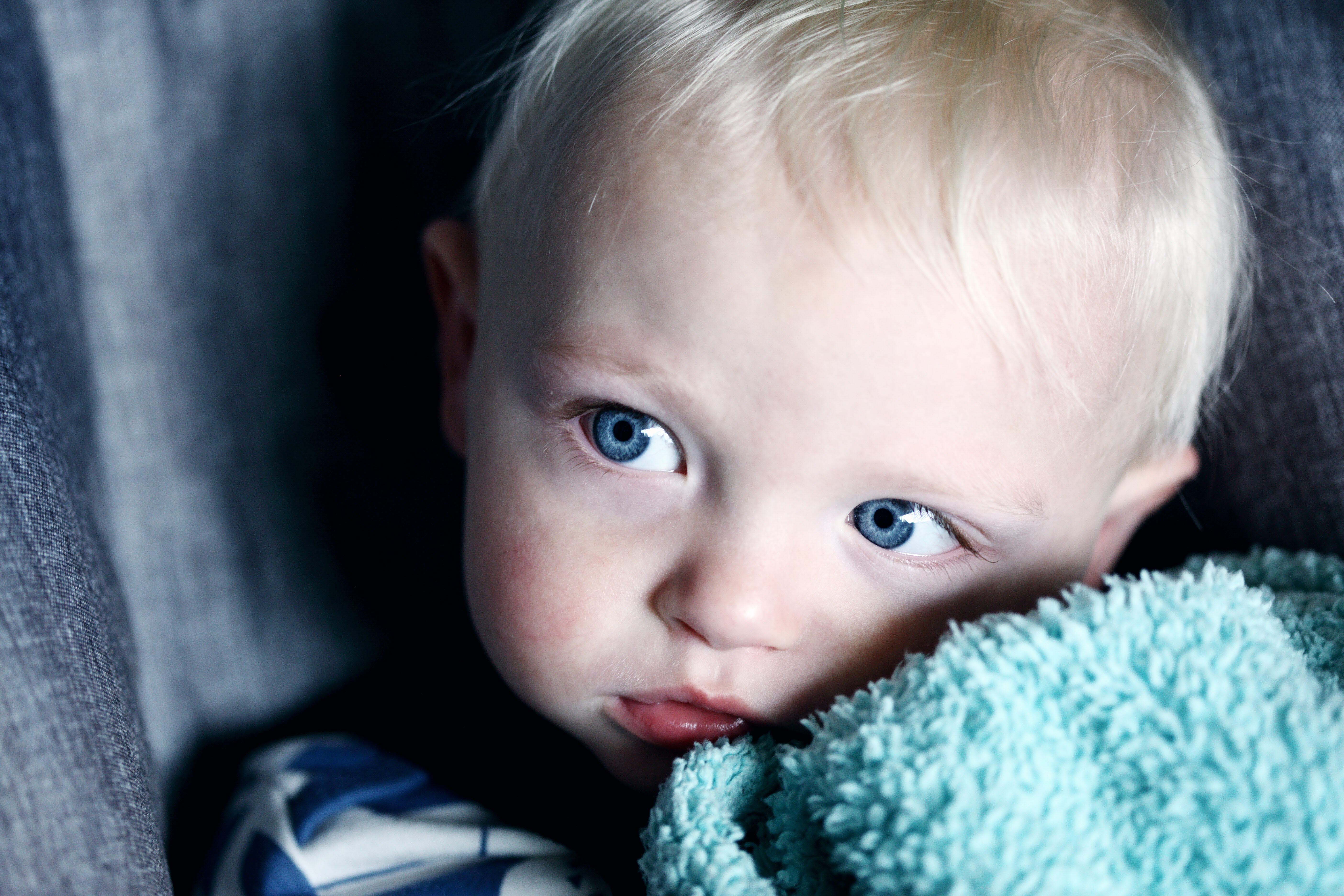 Child snuggling a blanket