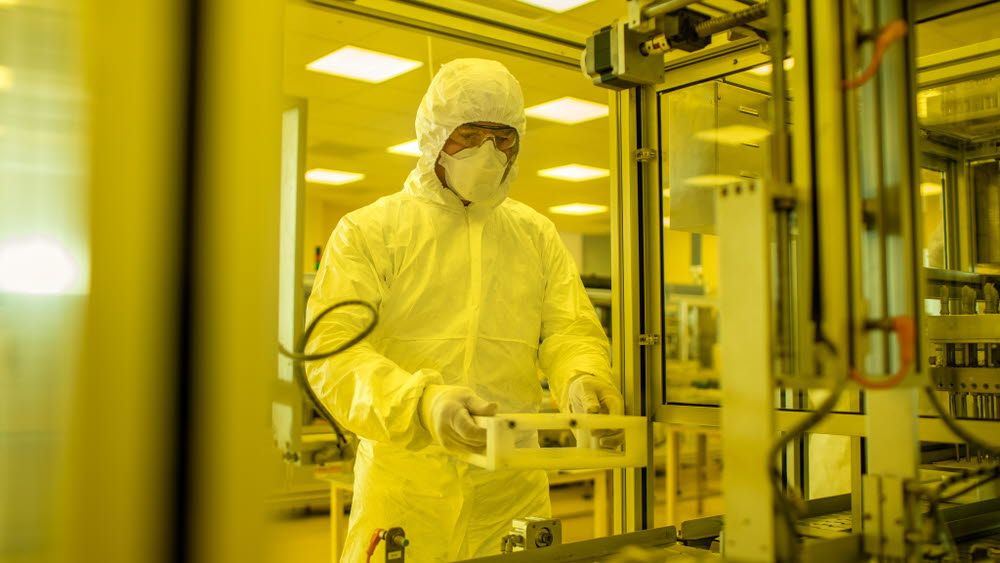 A male worker is working in a sterile room.