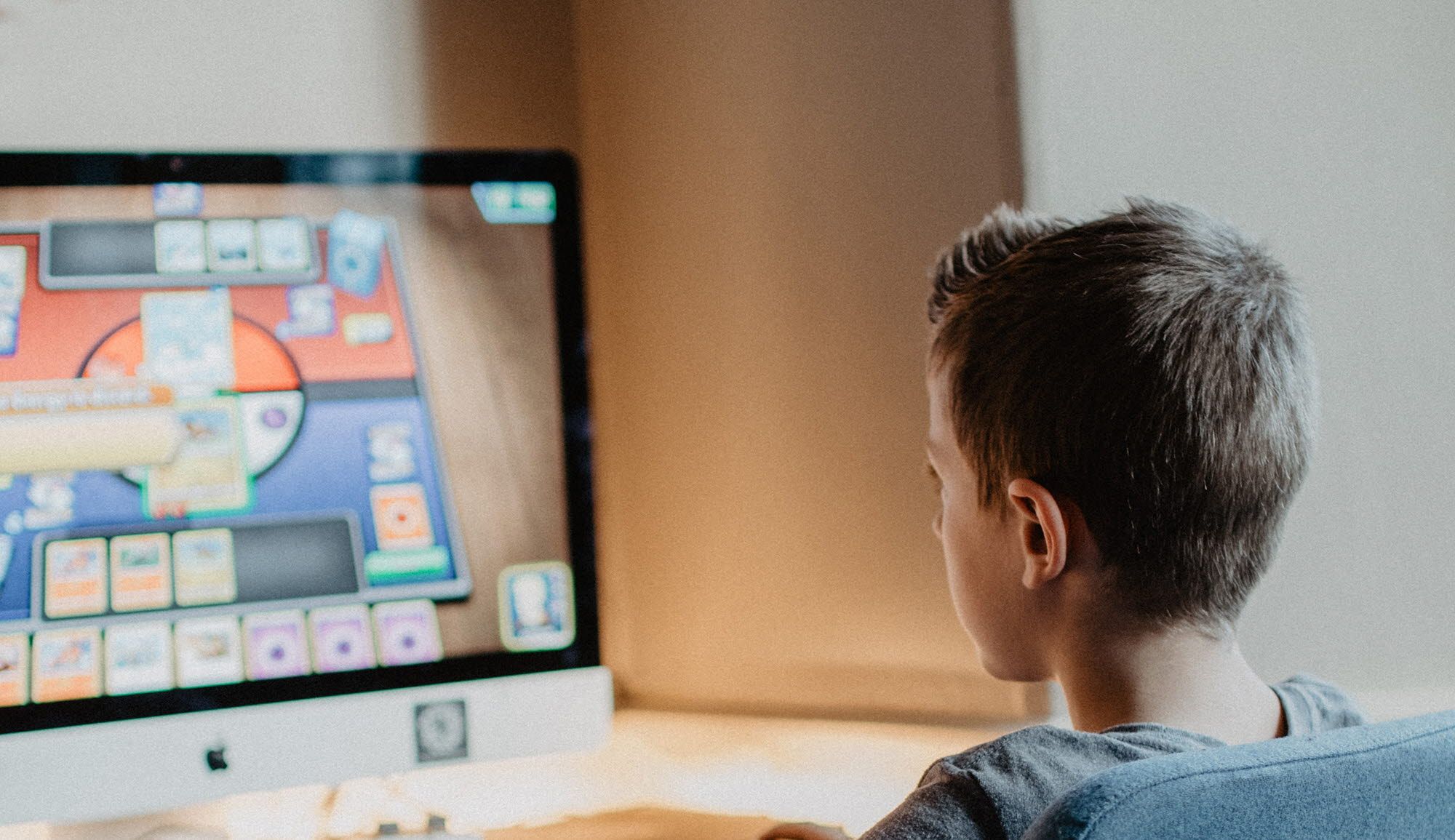 Child sitting in front of the computer playing games