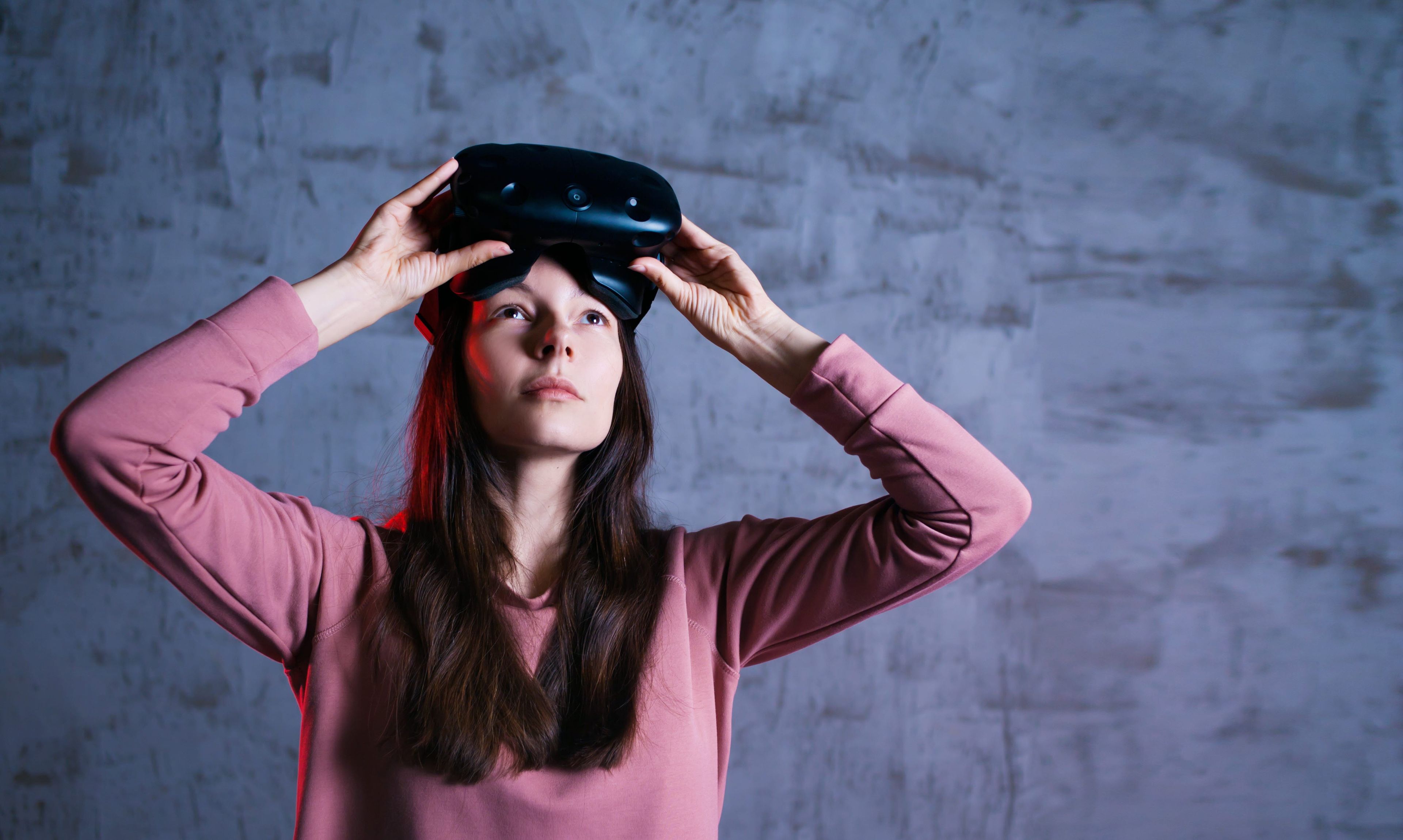 Woman removing her VR headset