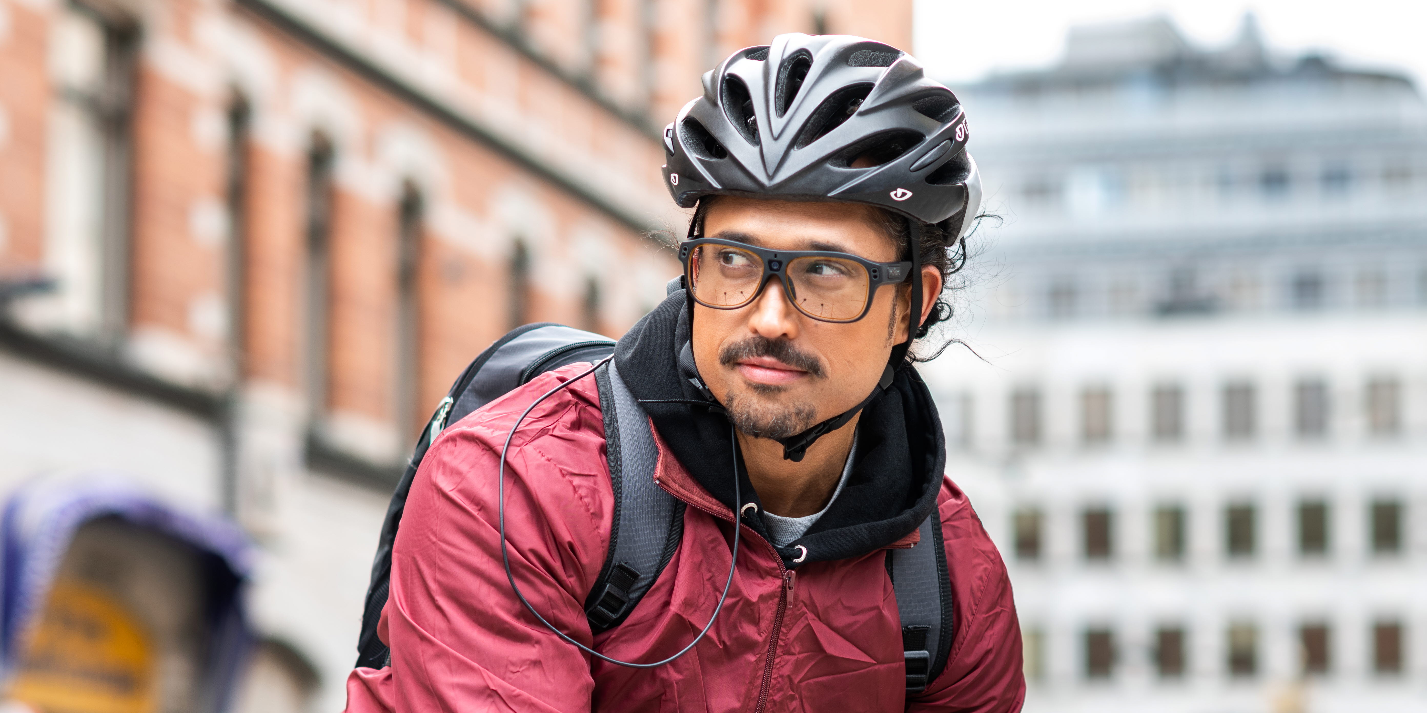 Person wearing Tobii Pro Glasses 3 riding a bike