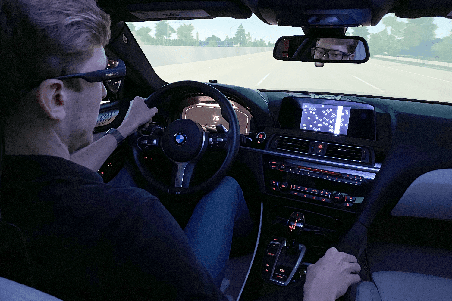 A person driving a car using Tobii Pro Glasses 3