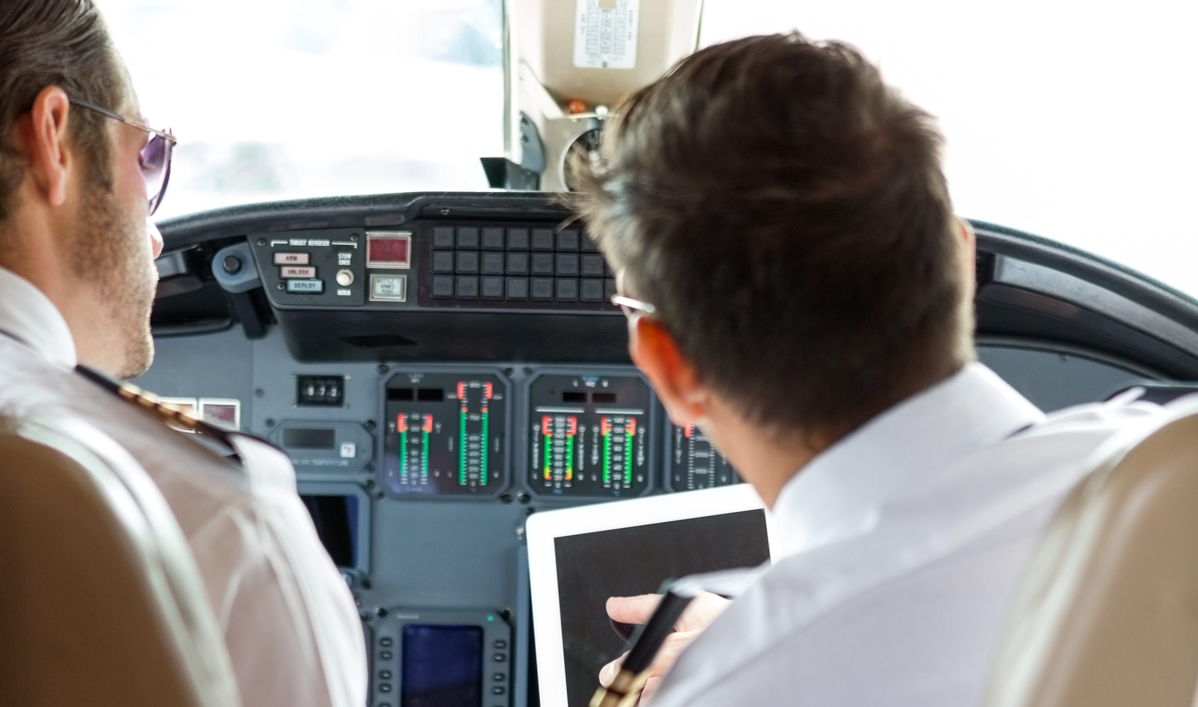 2 pilot doing a safety check in the cockpit