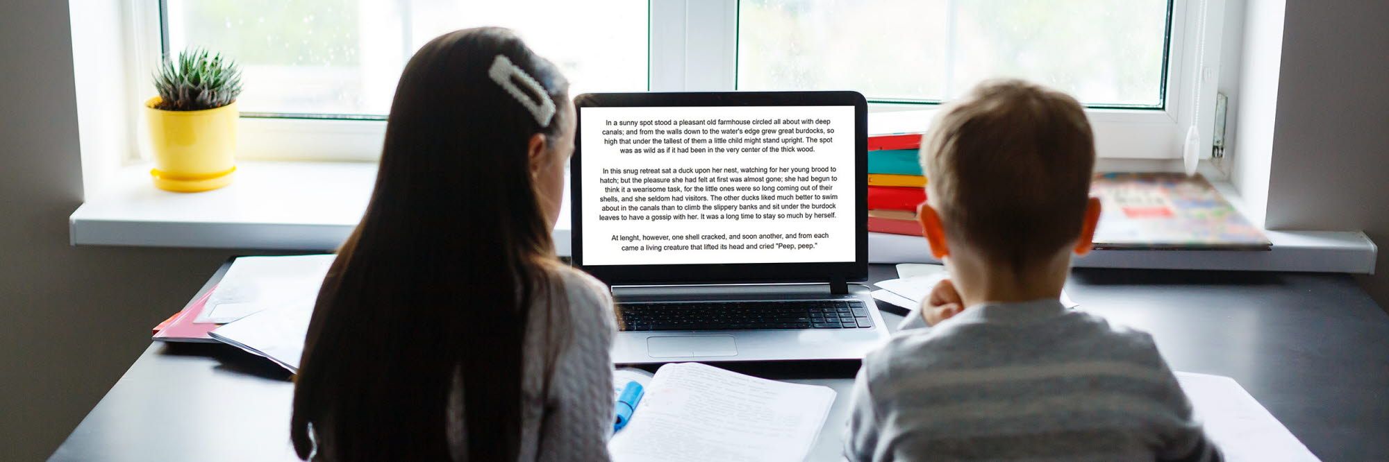 Children reading on a screen