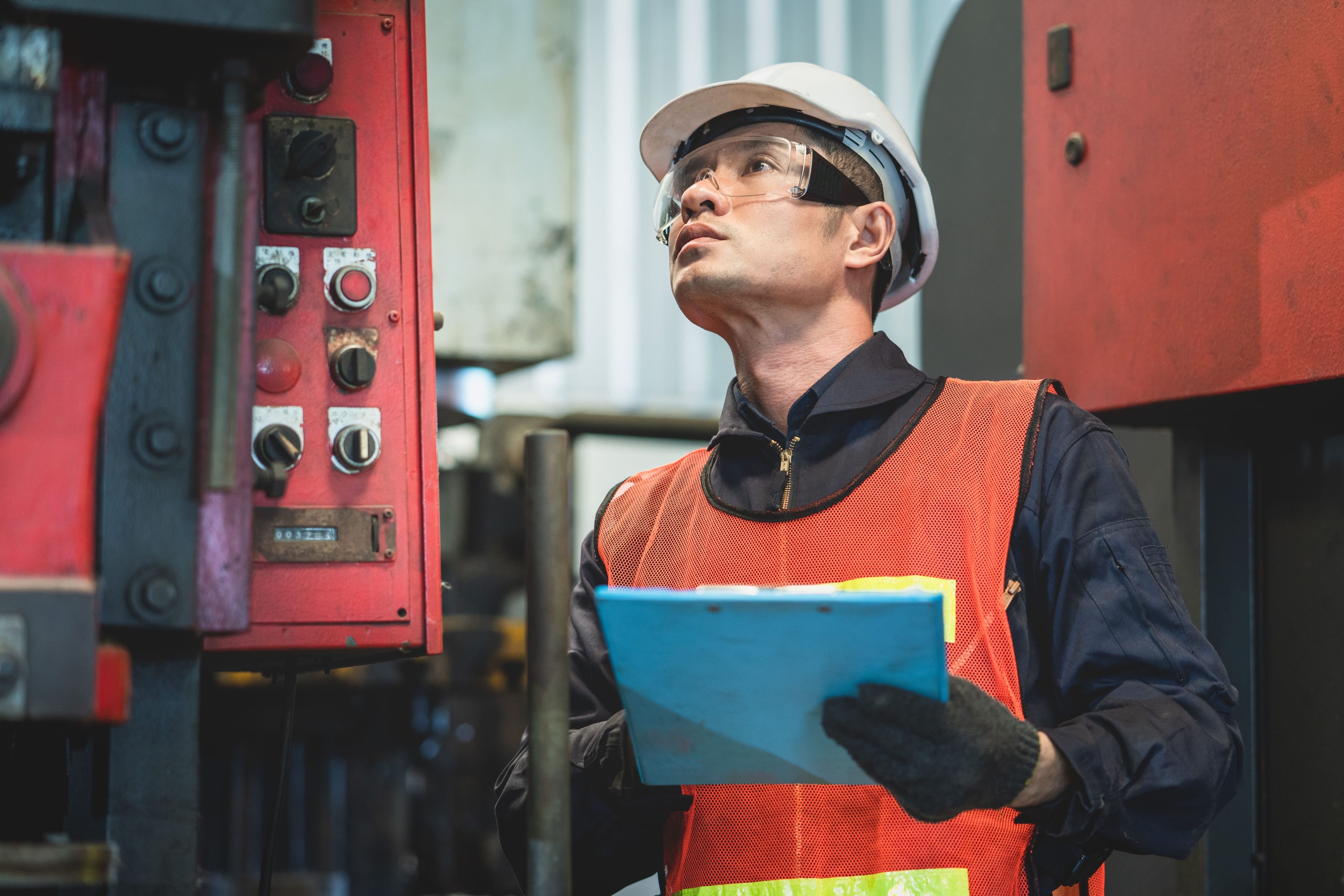 Worker looking at machinery