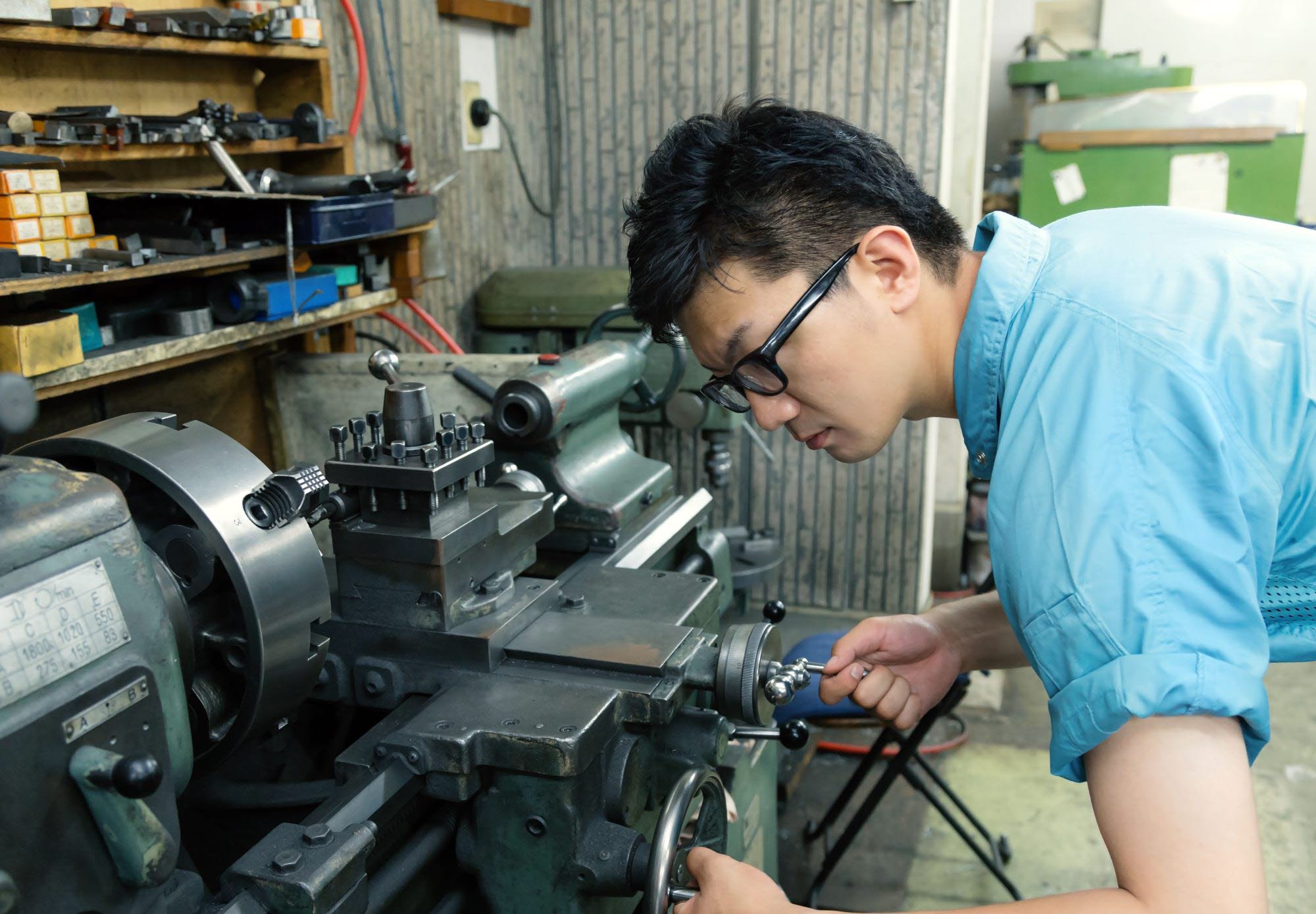 Male employee operating a machine.
