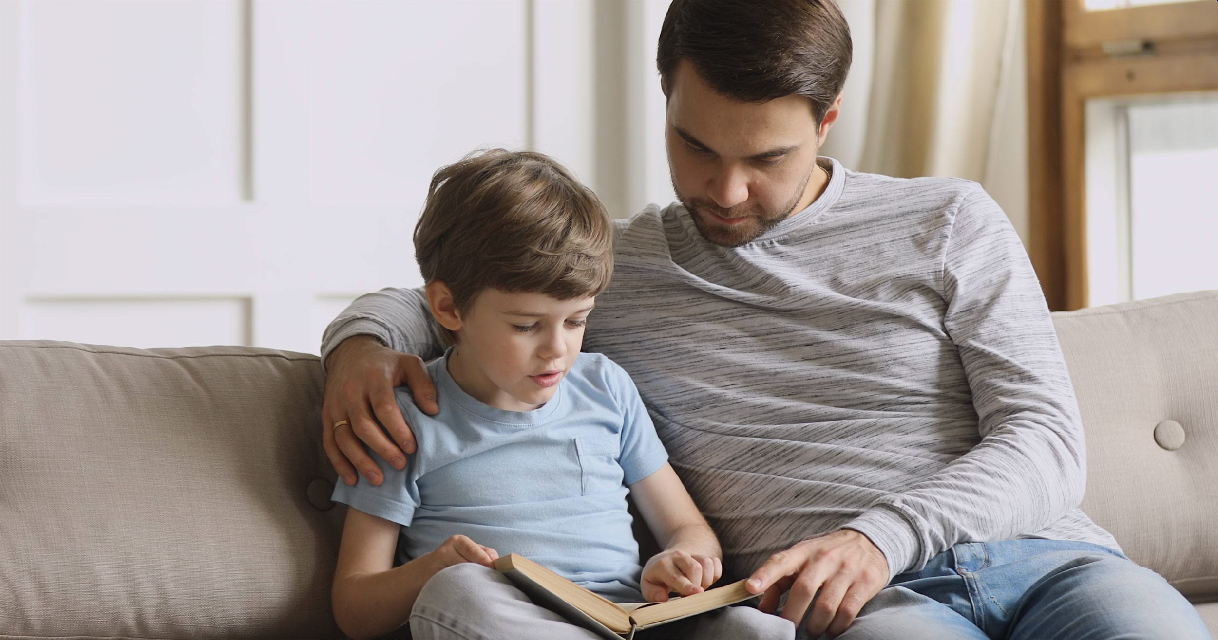 Father reading a book with his child