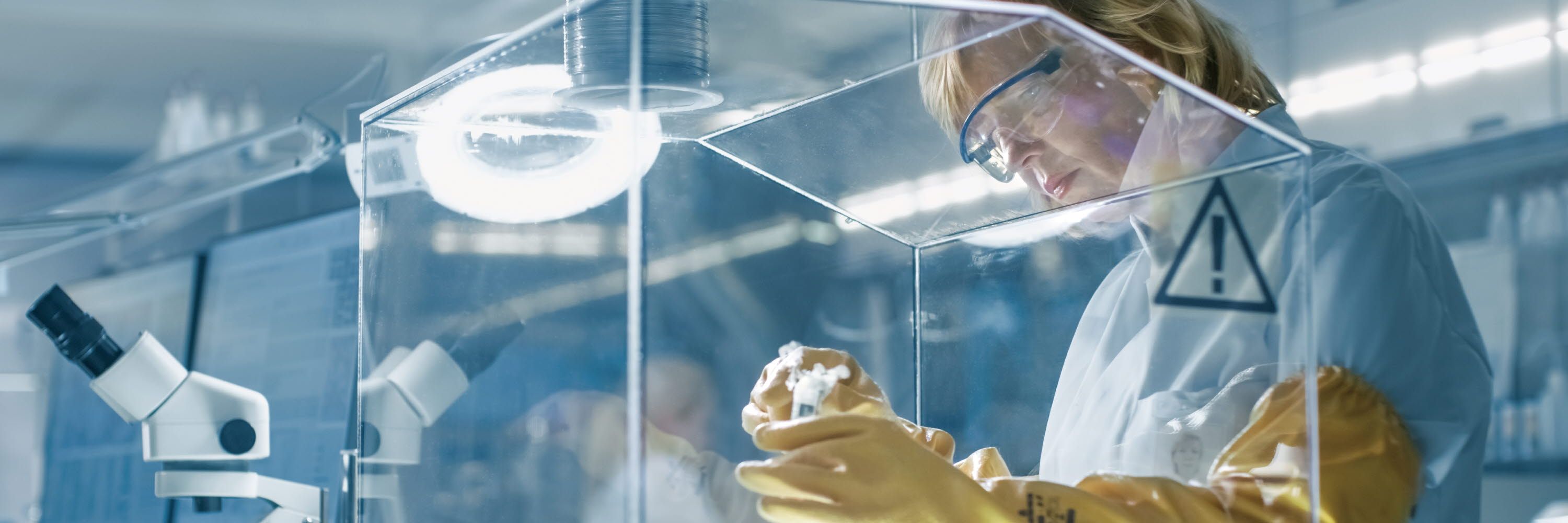 A woman is experimenting in a sterile room.