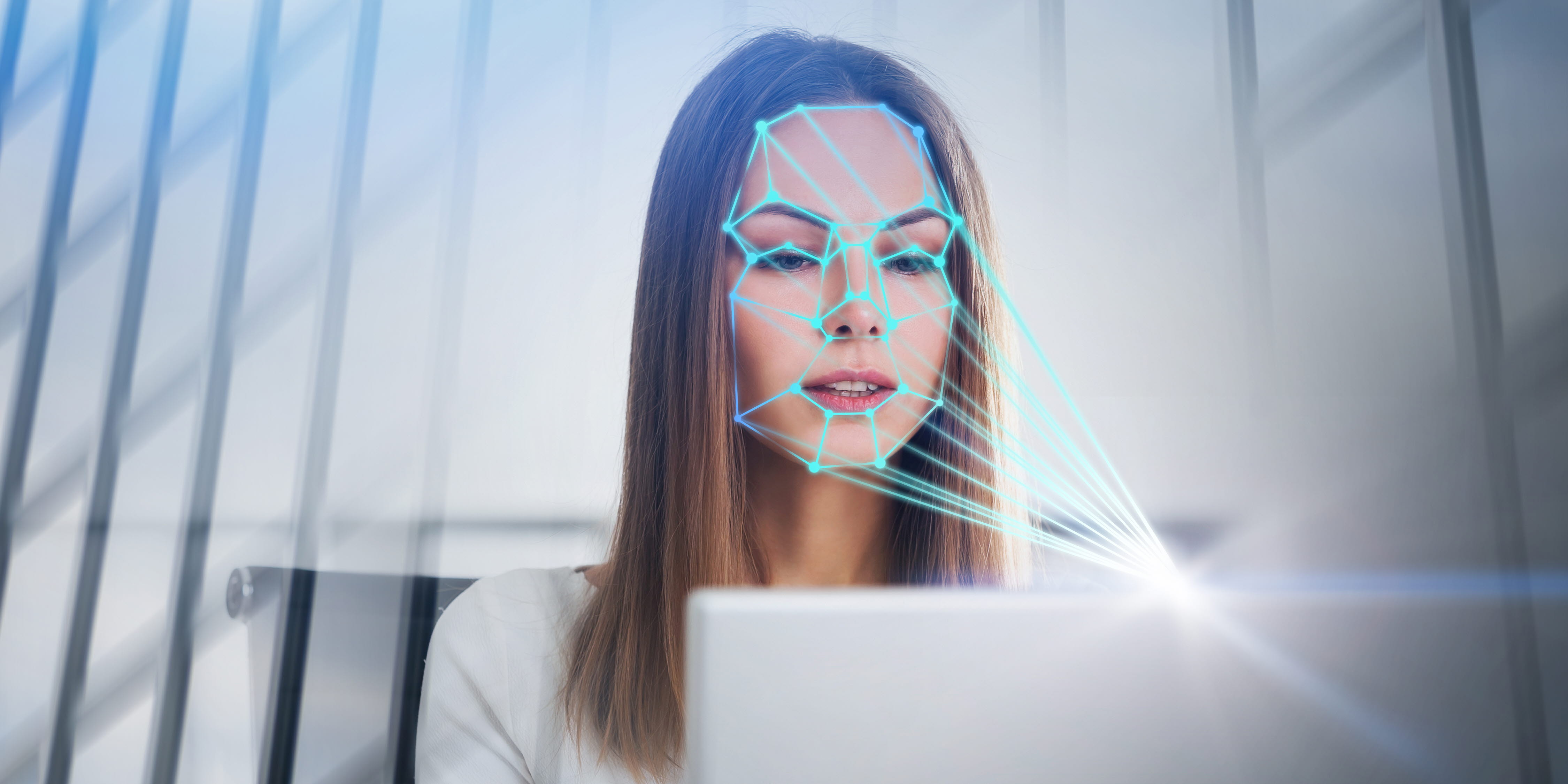 Woman looking at a computer emotion recognition